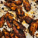 Charred chicken wings on foil