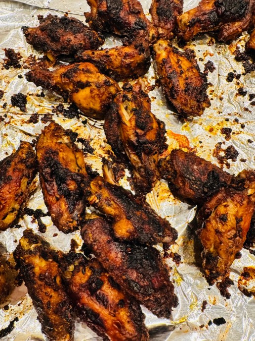 Charred chicken wings on foil