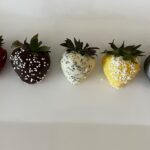 Colorful chocolate-covered strawberries arranged neatly