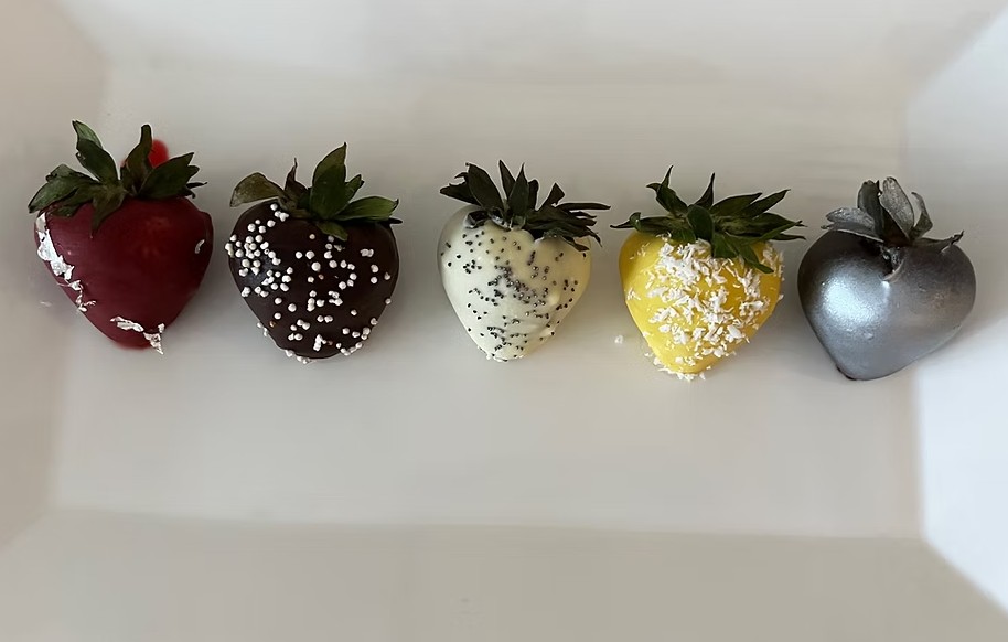 Colorful chocolate-covered strawberries arranged neatly