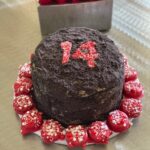 Chocolate cake with red decorations