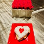 Red roses and heart-shaped dessert