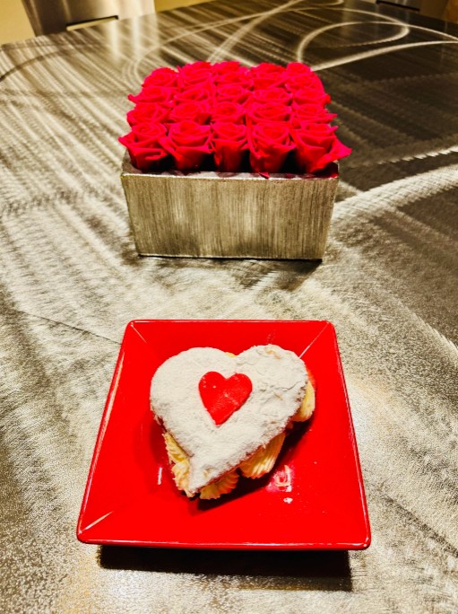 Red roses and heart-shaped dessert