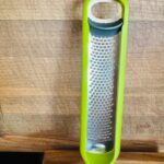 Green and silver kitchen grater