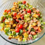 Colorful lobster roll panzanella salad with croutons and vegetables