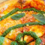 Pizza with pesto and basil toppings