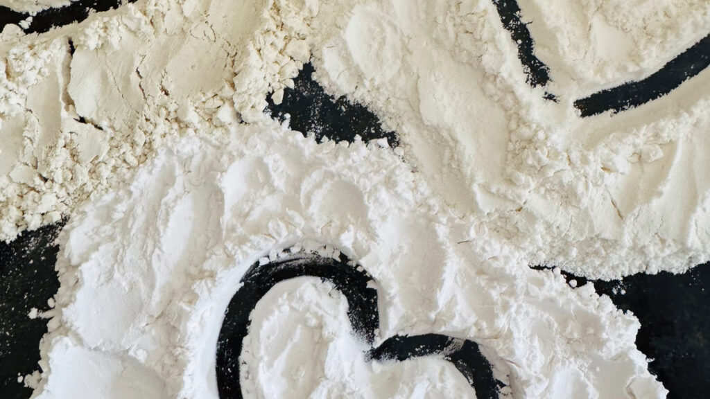 Flour scattered with black markings.