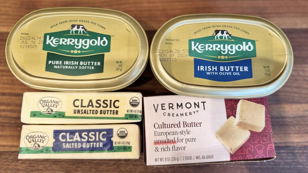 Different types of butter on a wooden board